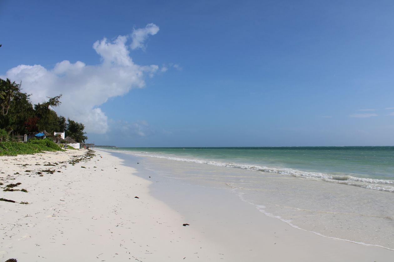 White sand beach and turquoise Indian Ocean water in Zanzibar, Tanzania, the beach end of a Tanzania safari and Zanzibar trip
