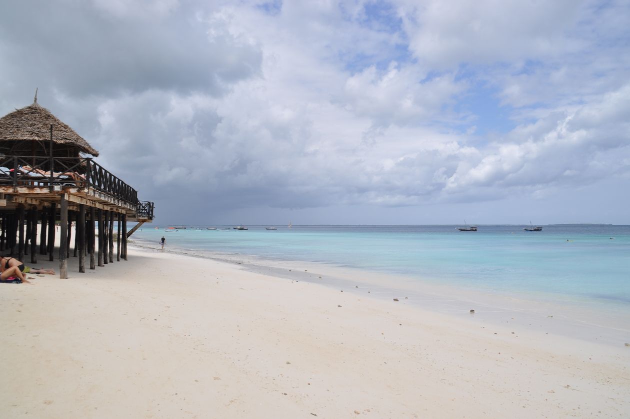 Azure water and a wooden pier at Nungwi beach in northern Zanzibar after a Tanzania safari